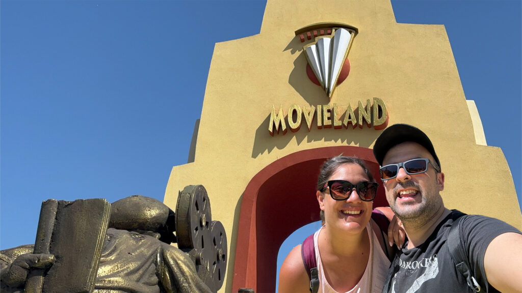 Michael e Alessia di Red Lace sorridono davanti all'insegna di Movieland, il parco divertimenti sul Lago di Garda